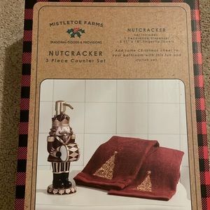 New in box nutcracker soap dispenser and two holiday themed hand towels